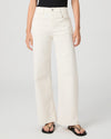 Person wearing white Paige jeans on a plain background