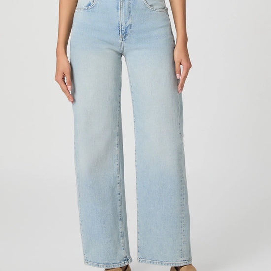 Light blue jeans worn by a person on a white background