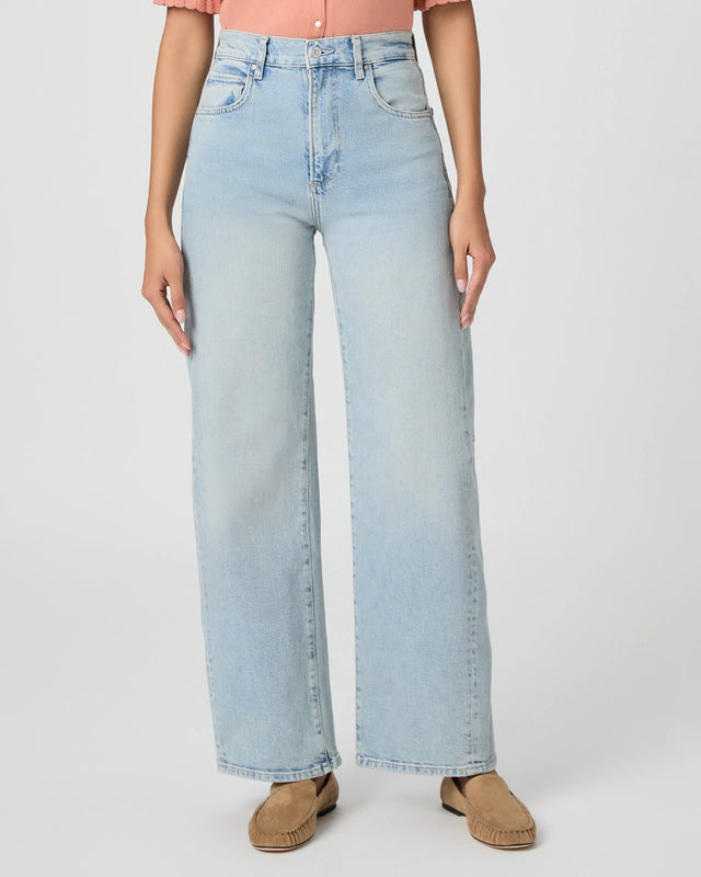 Light blue jeans worn by a person on a white background