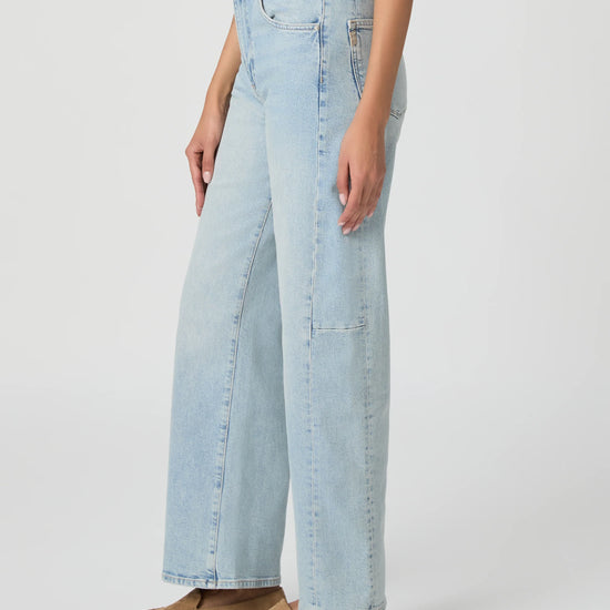 Light blue jeans worn by a person on a white background