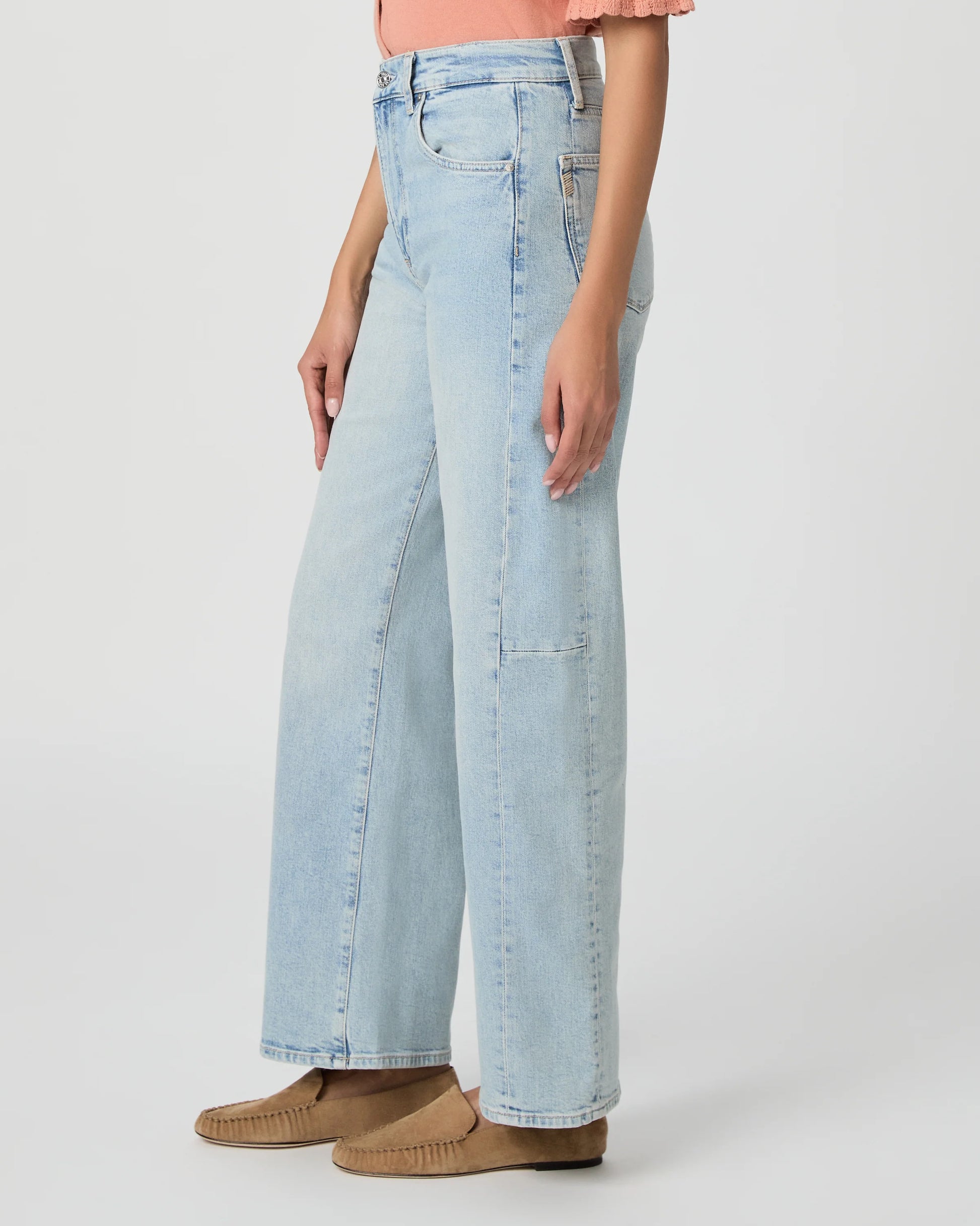 Light blue jeans worn by a person on a white background
