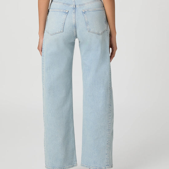 Light blue jeans worn by a person on a white background