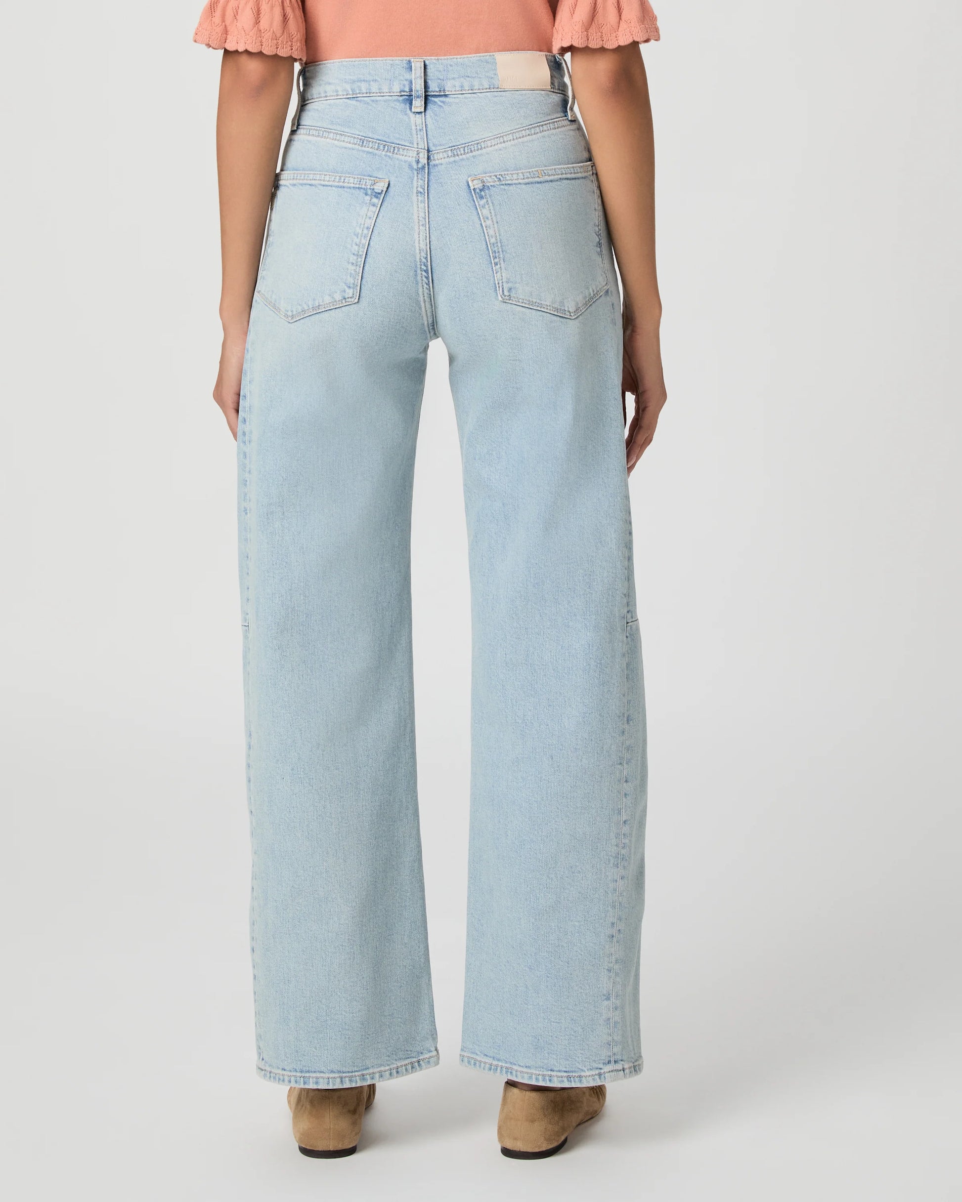 Light blue jeans worn by a person on a white background