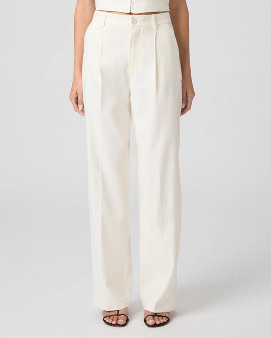 Person wearing white wide-leg pants on a plain background