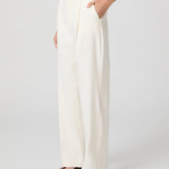 White wide-leg pants worn by a person on a plain background
