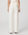 Person wearing white pants on a plain background