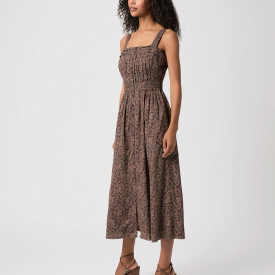 Woman modelling brown paisley dress side view