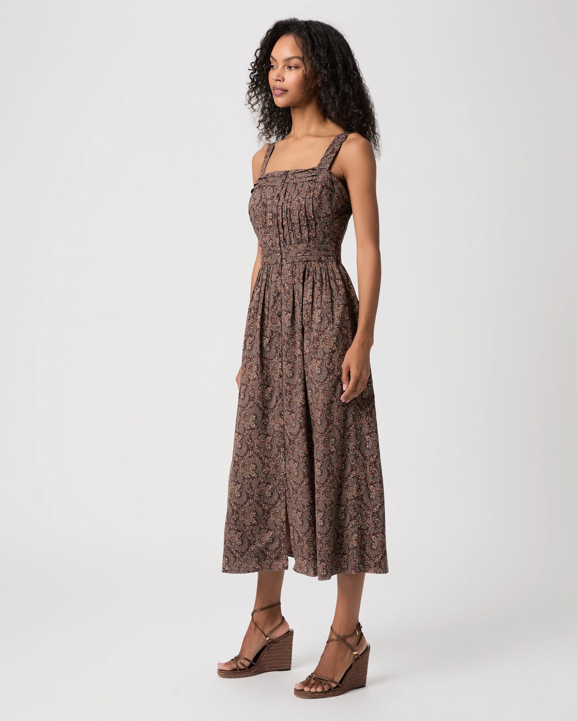 Woman modelling brown paisley dress side view