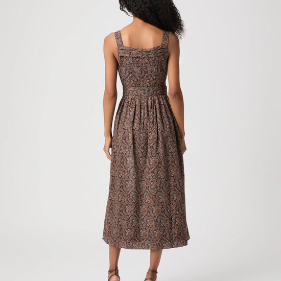 Woman modelling brown paisley dress rear view