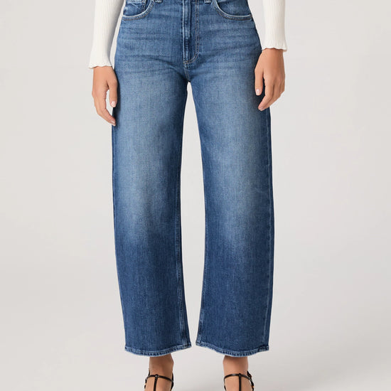 Person wearing blue jeans on a white background