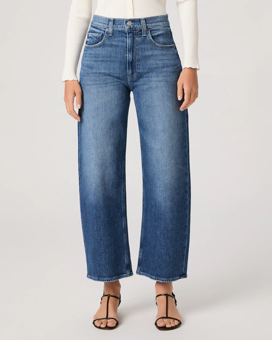 Person wearing blue jeans on a white background