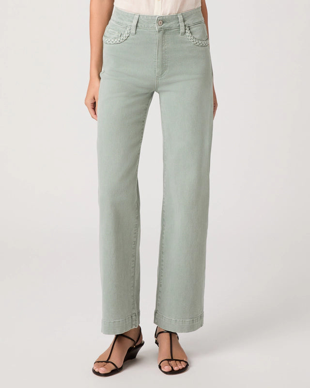 Light green jeans worn by a person on a white background