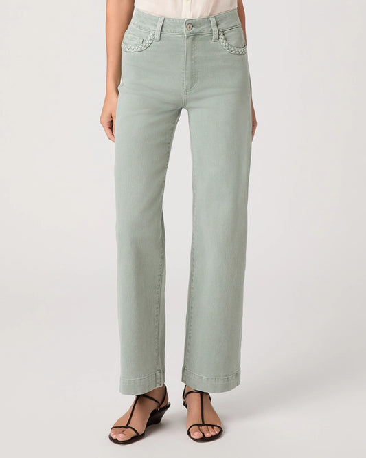 Light green jeans worn by a person on a white background