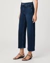 Person wearing dark blue jeans on a white background