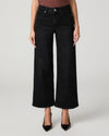 A model wearing a pair of black wide-leg cropped jeans with a ribbed top and black pointed-toe heels, photographed against a light gray studio background.