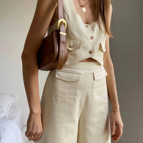 Cream cropped waistcoat with button fastening and two front patch pockets