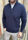 Male model wearing a navy cashmere quarter zip jumper.