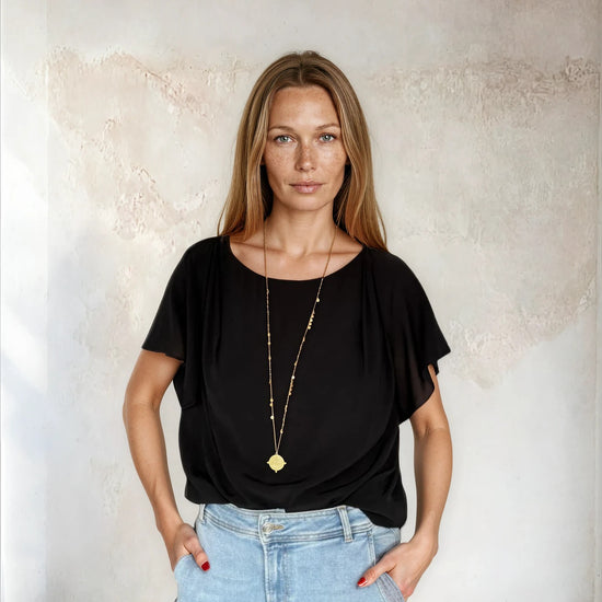 Black flutter sleeve top from Sirens worn with blue denim 