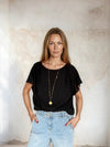 Black flutter sleeve top from Sirens worn with blue denim 