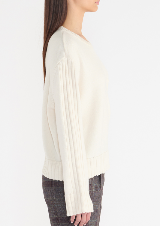 Off white jumper with rib detailing on the chest pocket, cuffs, sleeves, back and neckline. Side view. 