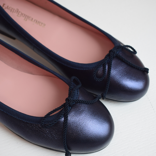 Shimmer navy blue classic round toe ballet pumps with navy thin ribbed binding and navy thin rope bow on toe