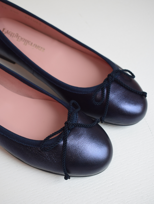 Shimmer navy blue classic round toe ballet pumps with navy thin ribbed binding and navy thin rope bow on toe