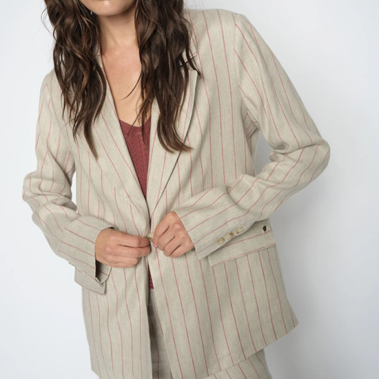 model wearing pinstripe suit on plain background
