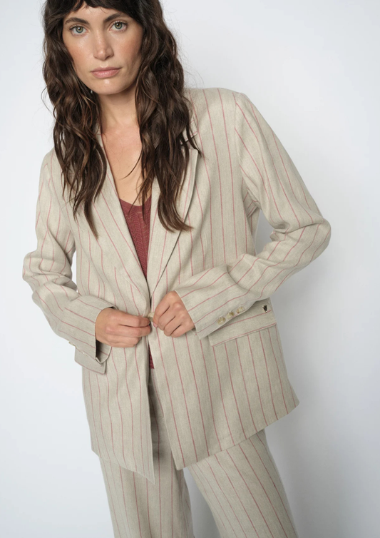 model wearing pinstripe suit on plain background