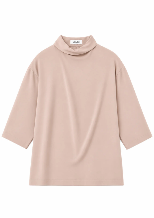 flat lay of a blush pink blouse on a white background
