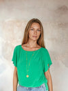 Green flutter sleeve top worn with blue jeans from Sirens