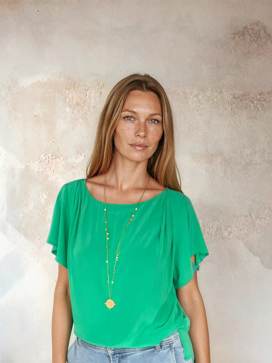 Green flutter sleeve top worn with blue jeans from Sirens