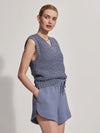 V neck textured  knitted vest in mid blue model shot in shorts 