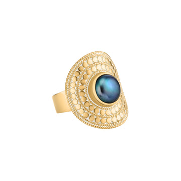 gold saddle style dotted ring with blue pearl in the centre