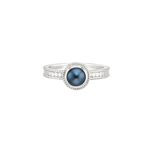 silver dotted ring with blue pearl in the centre