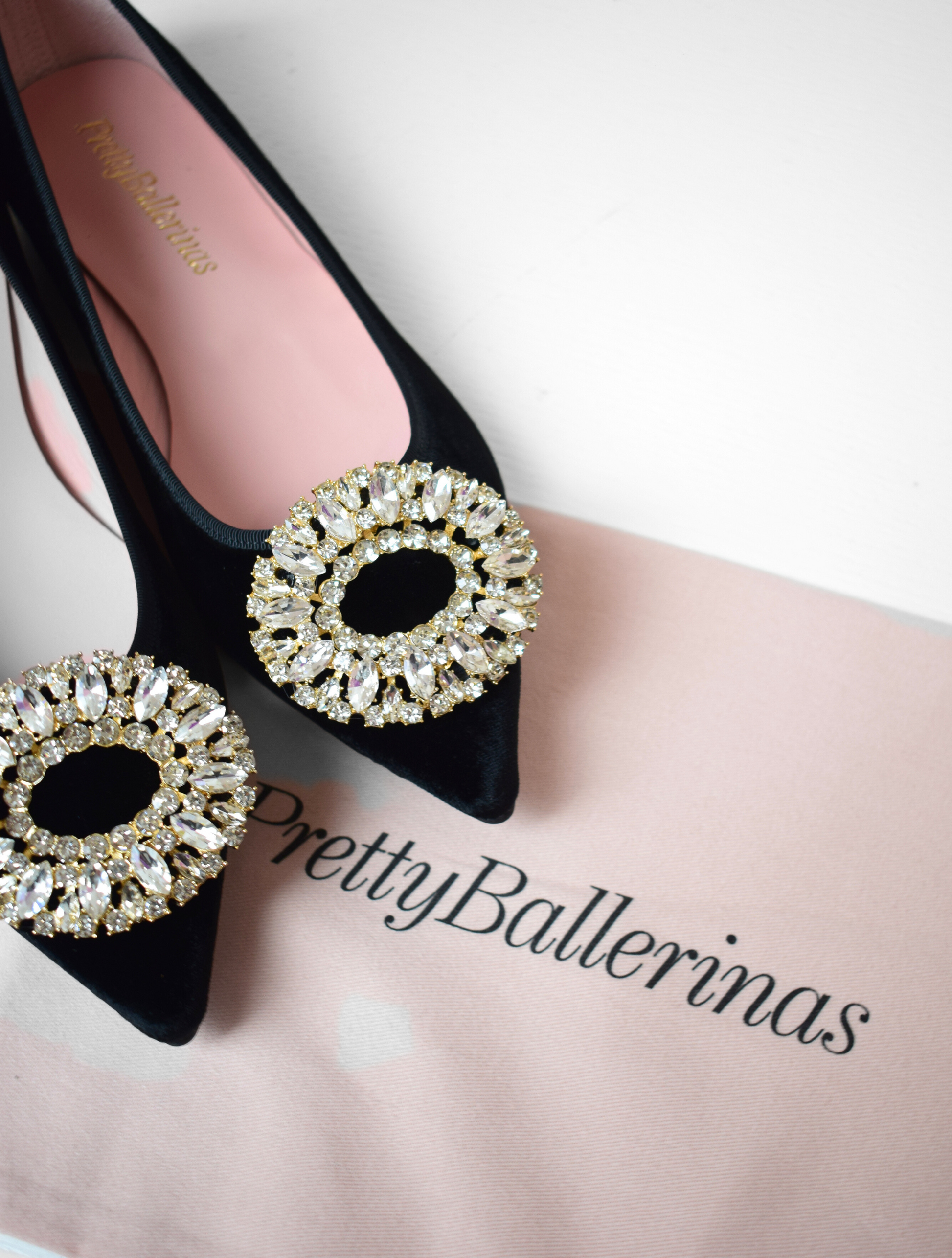 Black velvet pointed toe ballet pumps with gold and diamante brooch on toe