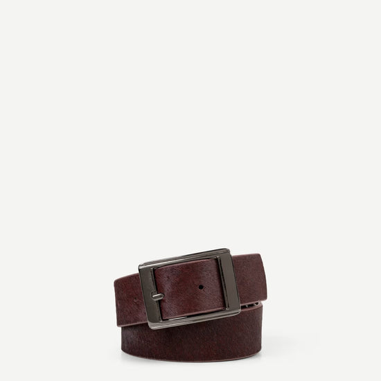 maroon leather belt with a silver buckle on a white background