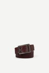 maroon leather belt with a silver buckle on a white background