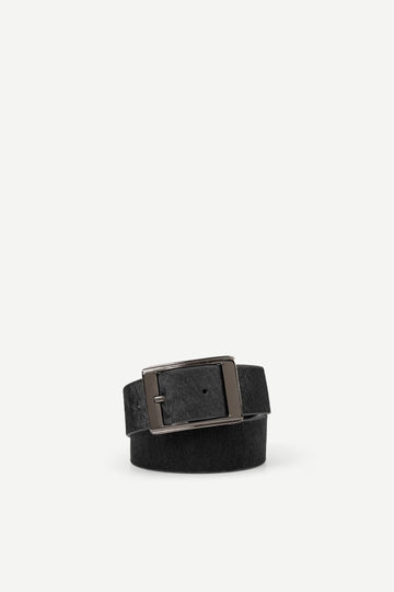 Blackhair on hide belt with a nickle buckle on a white background