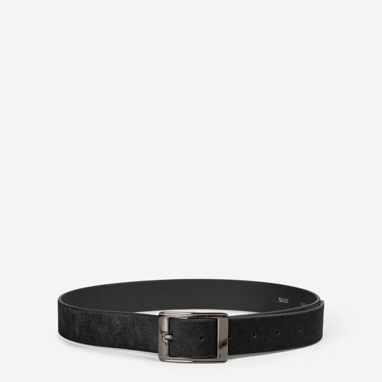 Black hair on hide belt with a nickle buckle on a white background