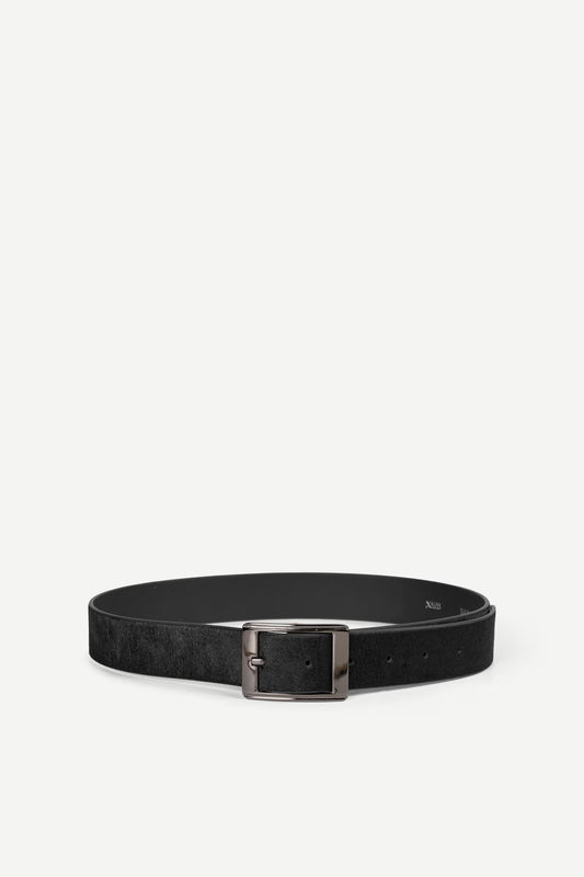 Black hair on hide belt with a nickle buckle on a white background