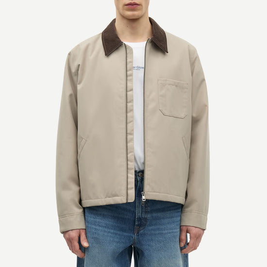 Man wearing a beige jacket with a brown collar by samsoe samsoe on a white background