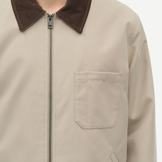 Beige jacket with brown collar on a white background close up