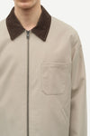 Beige jacket with brown collar on a white background close up