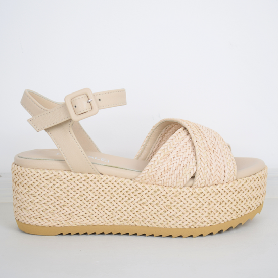 Blush coloured flatforms in a raffia