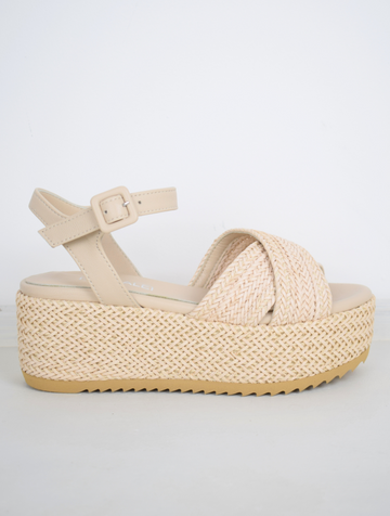 Blush coloured flatforms in a raffia