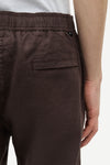 Brown pants by Samsoe Samsoe with a pocket on a white background