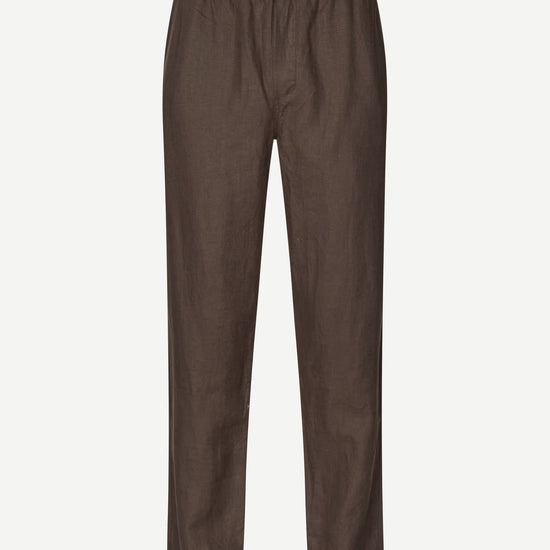 Brown trousers by Samsoe Samsoe on a white background