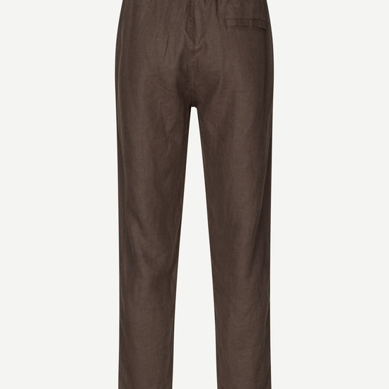 Brown trousers by Samsoe Samsoe on a white background rear view