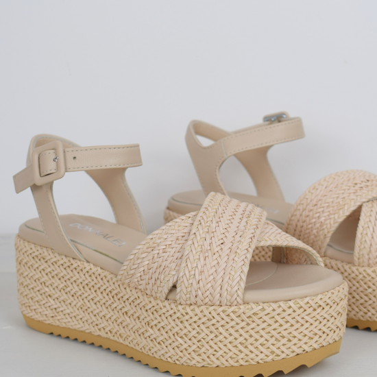 Blush coloured flatforms in a raffia