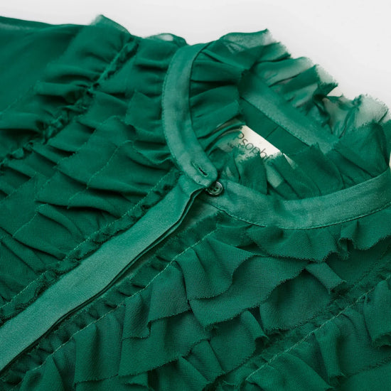 Close-up of a green ruffled garment on a white background